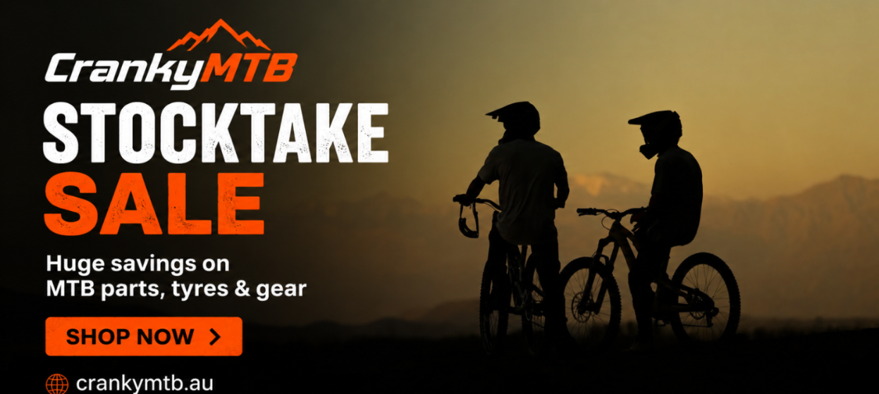 Crankymtb stocktake sale advertisement with silhouettes of people on bicycles against a mountainous background.