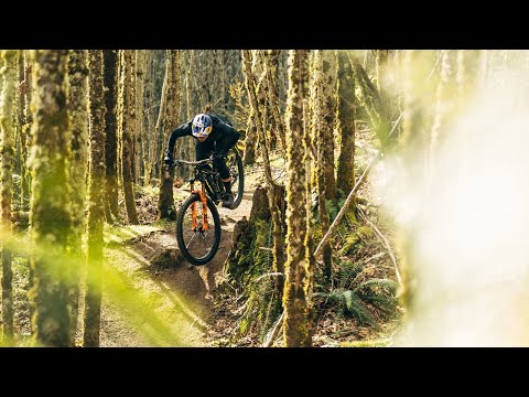 Mountain biker skillfully navigating a trail in a lush forest, showcasing the thrilling adventure of cycling.